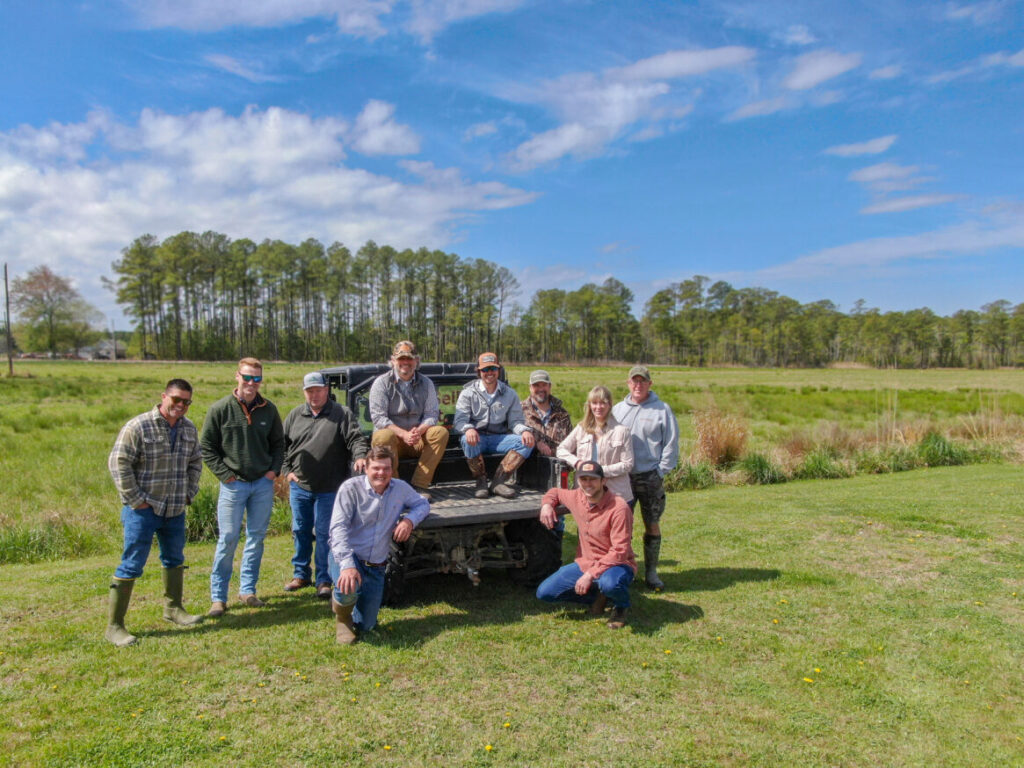 a group of people standing in front of a truck