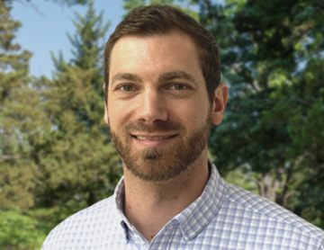 a man with a beard and a blue and white checkered shirt