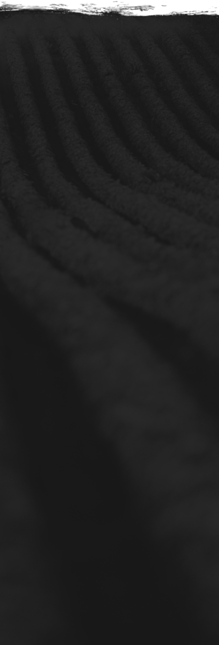 a black and white photo of a snowboarder going down a hill