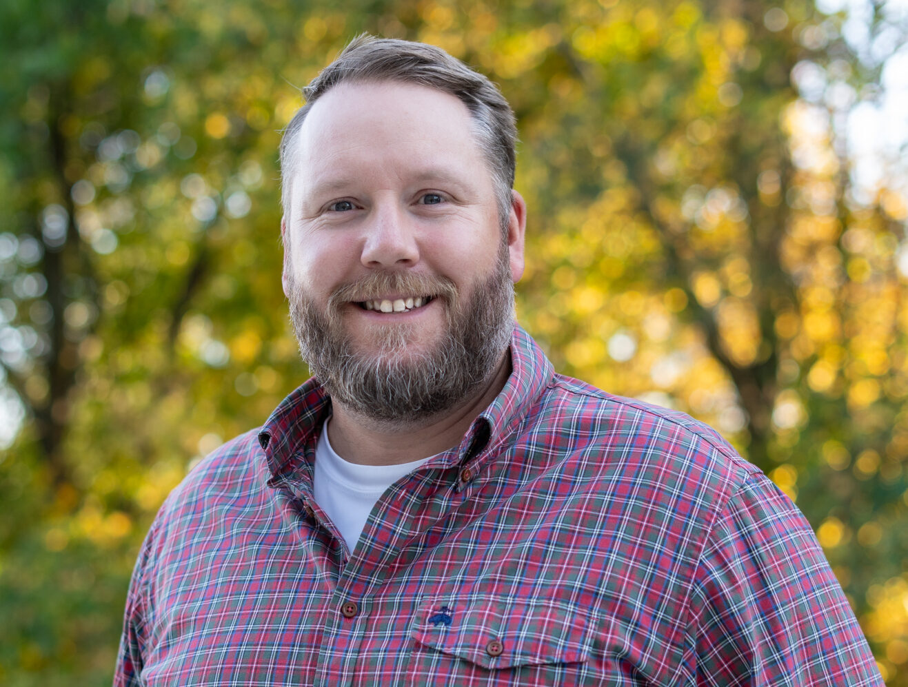 a man with a beard and a plaid shirt