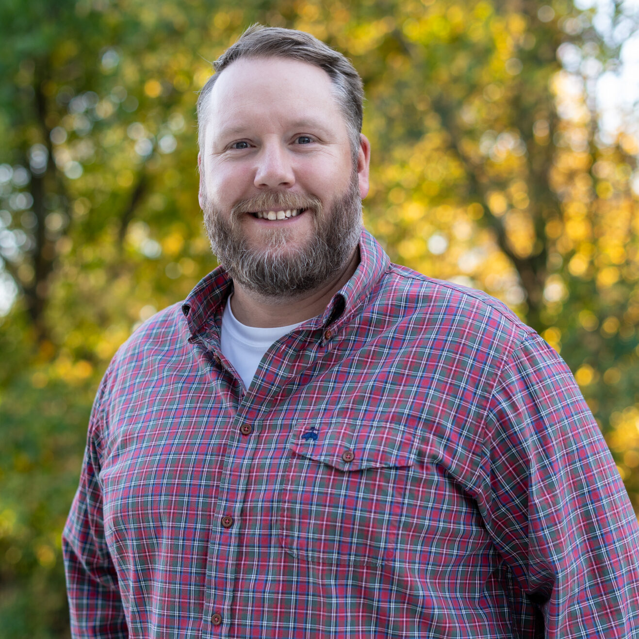 a man with a beard and a plaid shirt