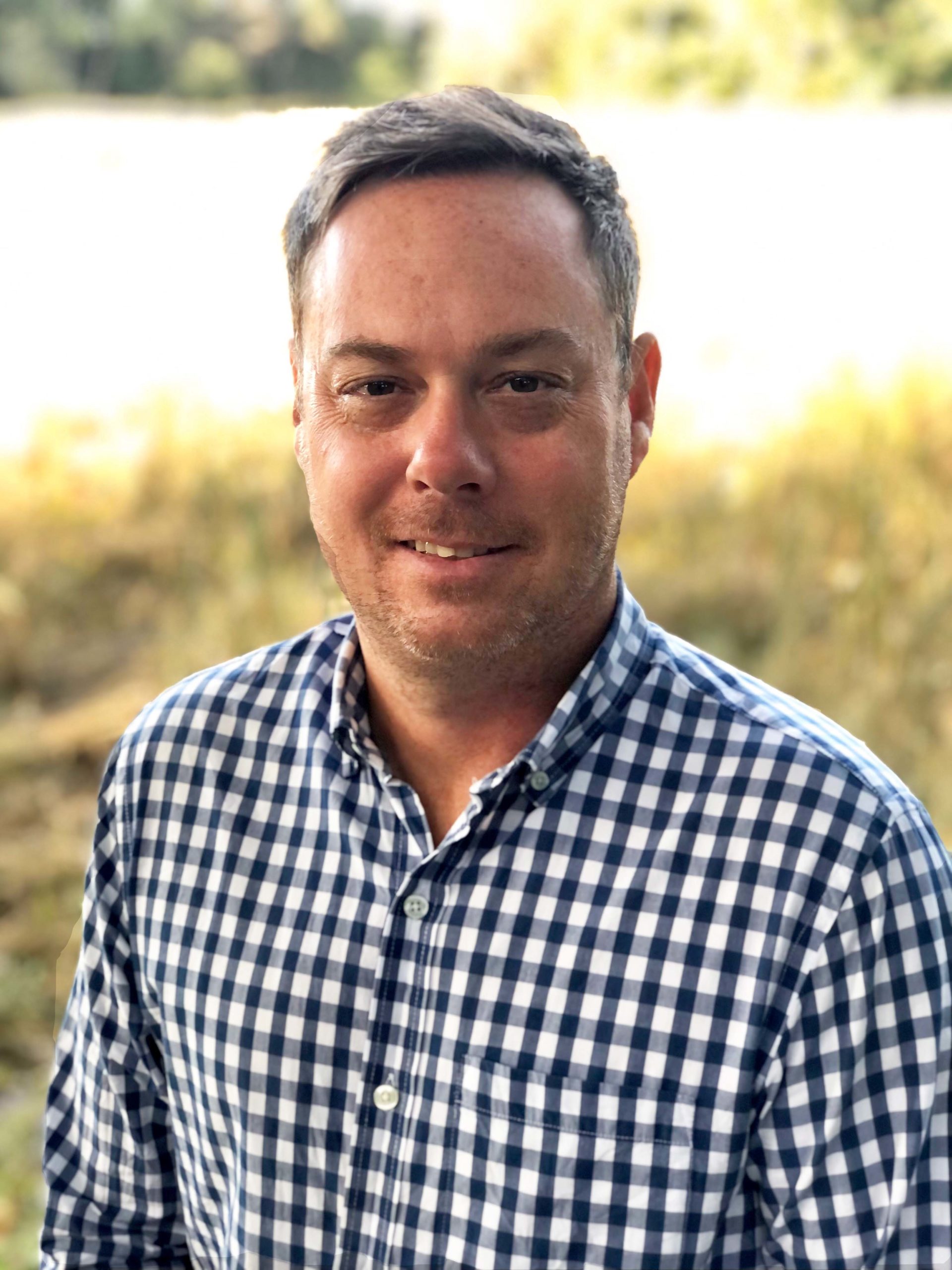 a man in a blue and white checkered shirt
