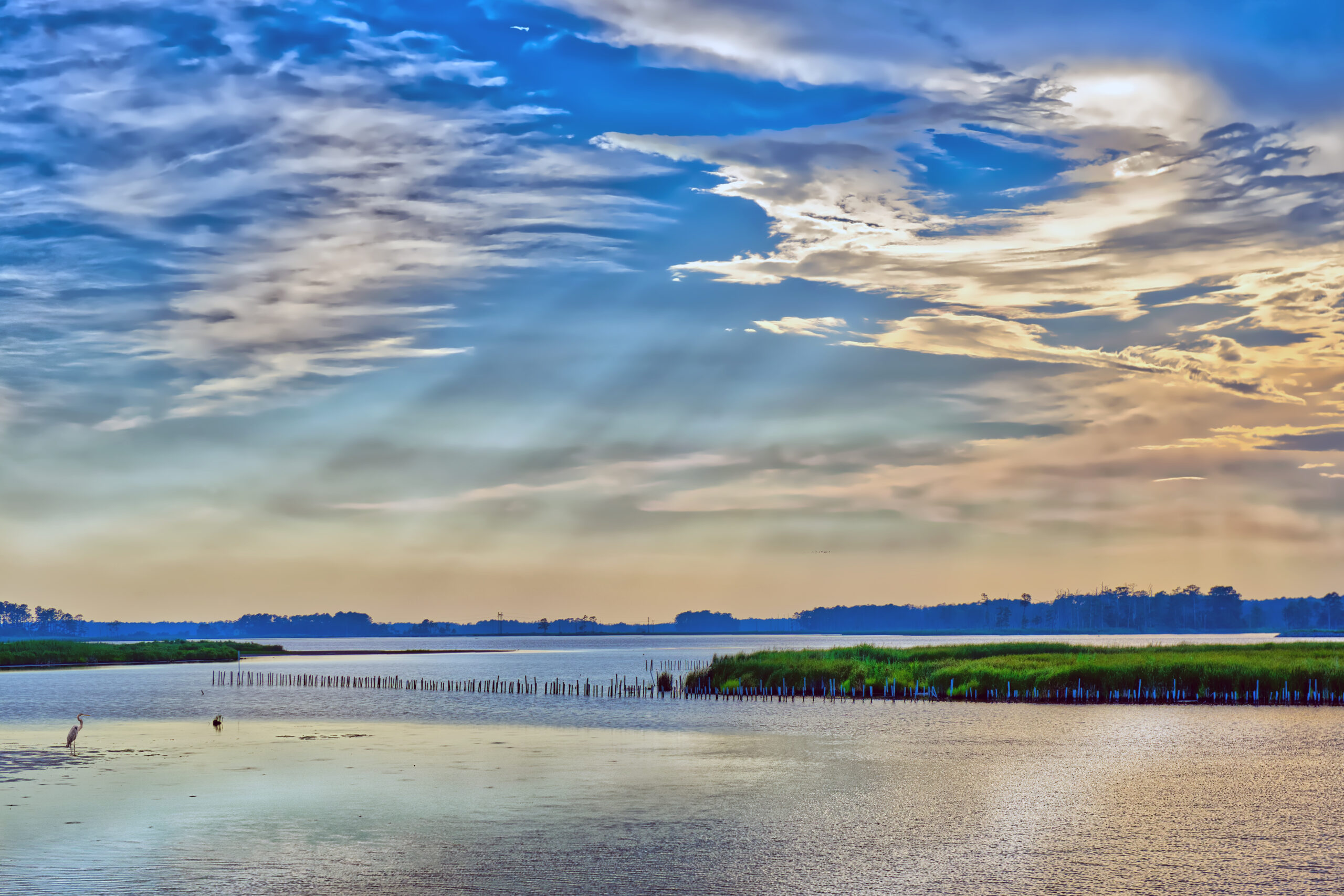 a body of water with a sky in the background