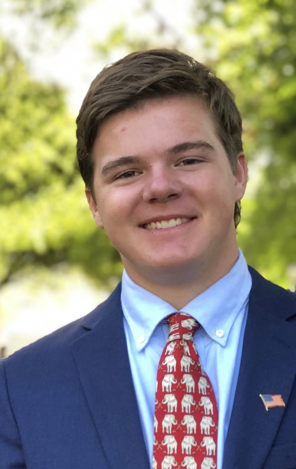 a man in a blue suit and red tie