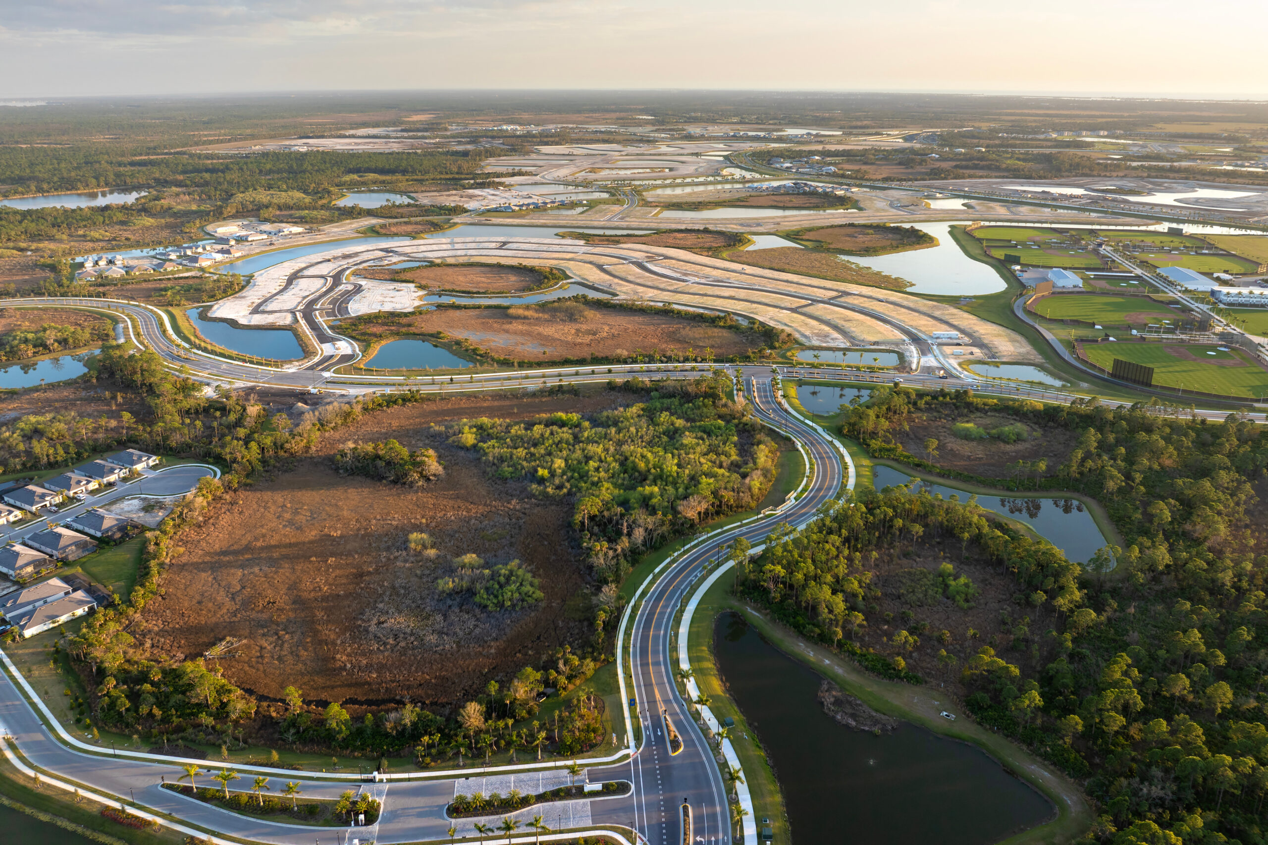 an aerial view of a road surrounded by water