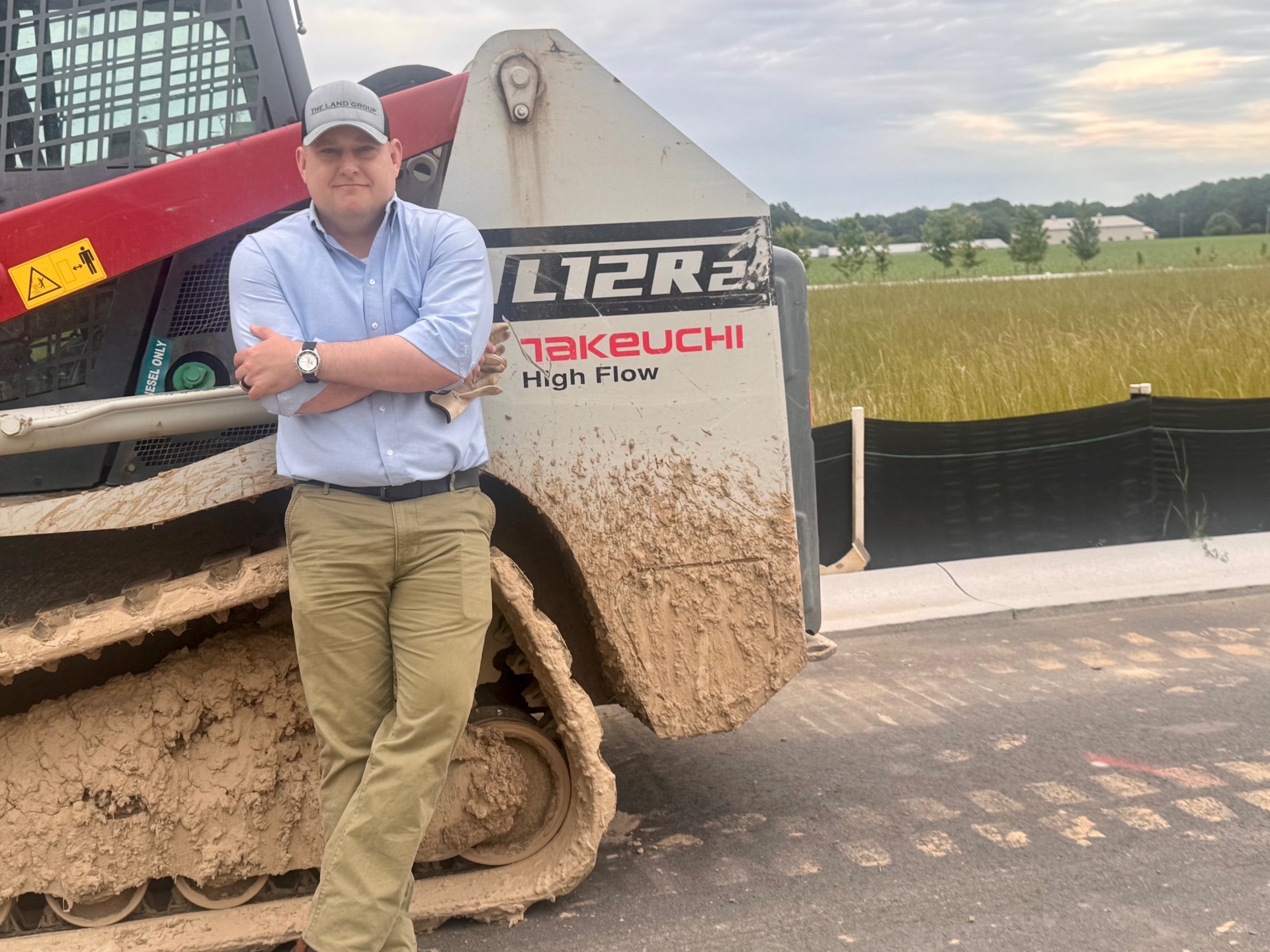a man standing in front of a tractor