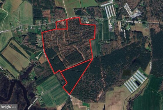 an aerial view of a red area in the middle of a field