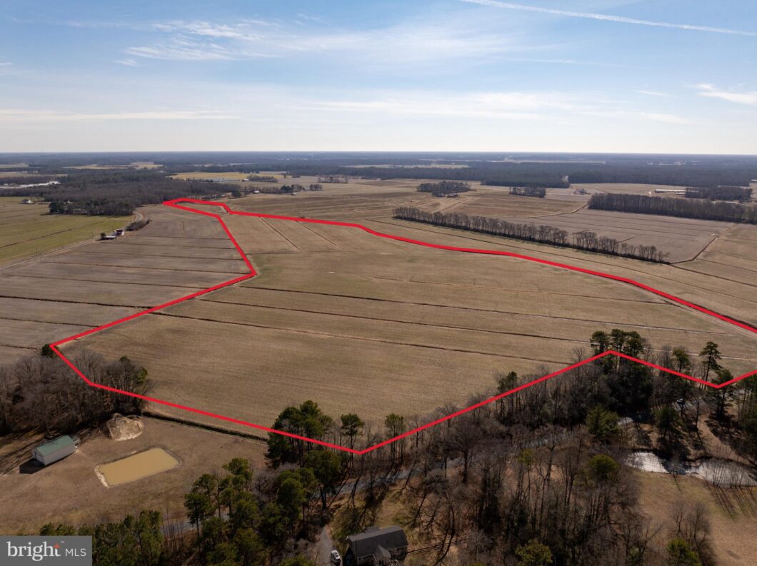an aerial view of a large field with a red line on it