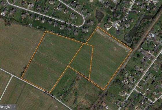 an aerial view of a vacant lot in the middle of a field