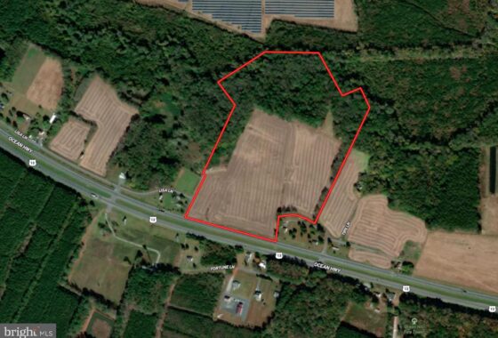 an aerial view of a road in the middle of a field